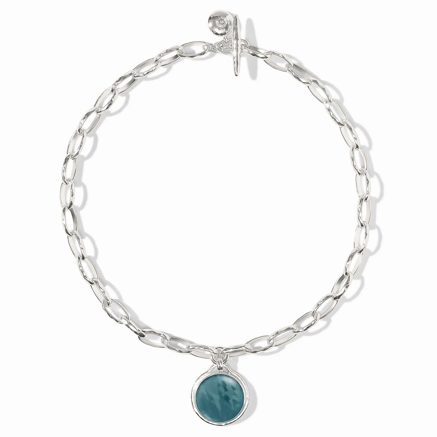 Elongated silver links, round iridescent Montana Blue stone charm, toggle clasp. Available in 16", 18", and 20" lengths.