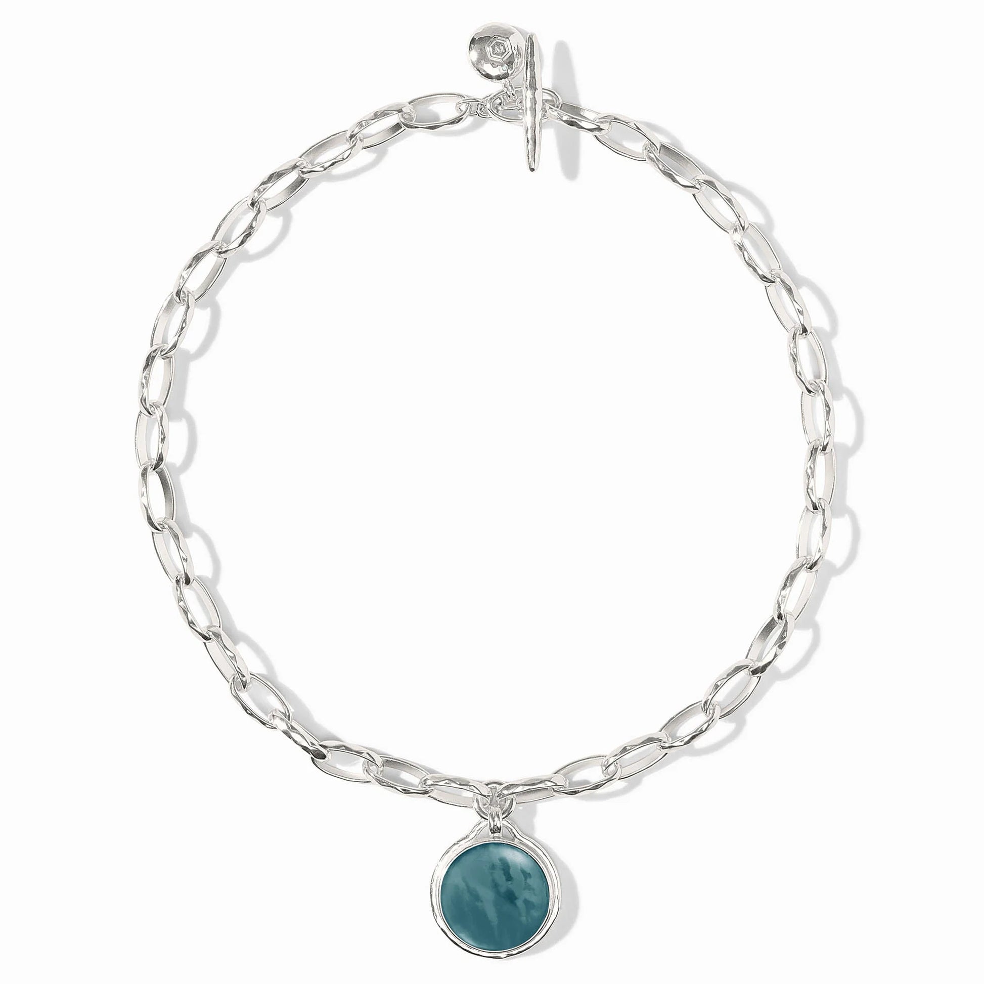 Elongated silver links, round iridescent Montana Blue stone charm, toggle clasp. Available in 16", 18", and 20" lengths.