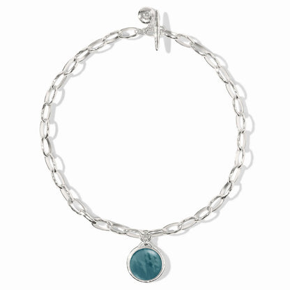 Elongated silver links, round iridescent Montana Blue stone charm, toggle clasp. Available in 16", 18", and 20" lengths.