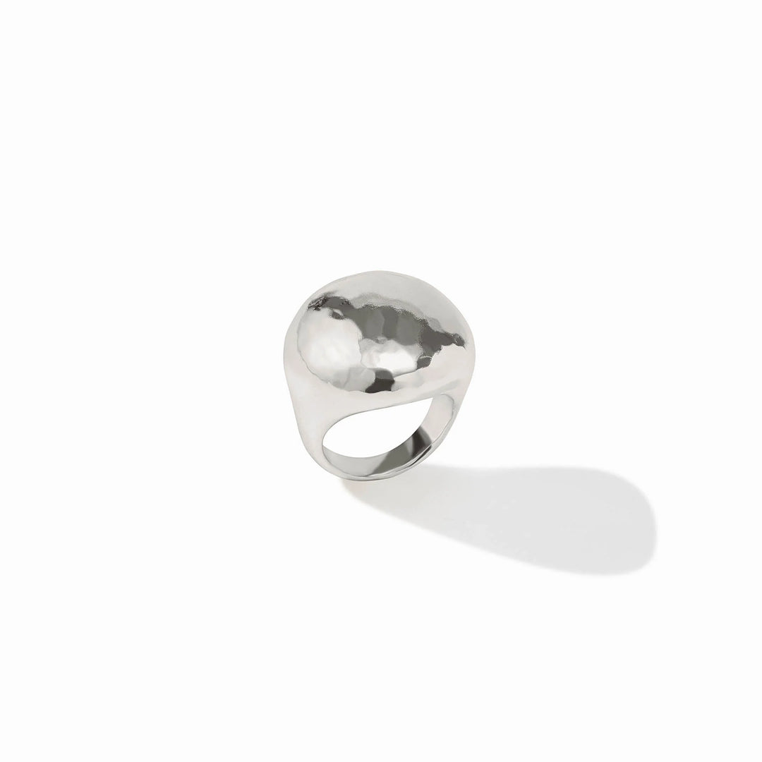 The Solara Ring Silver has a domed shape, hammered texture, and starburst engraving. Available in sizes 5–9.
