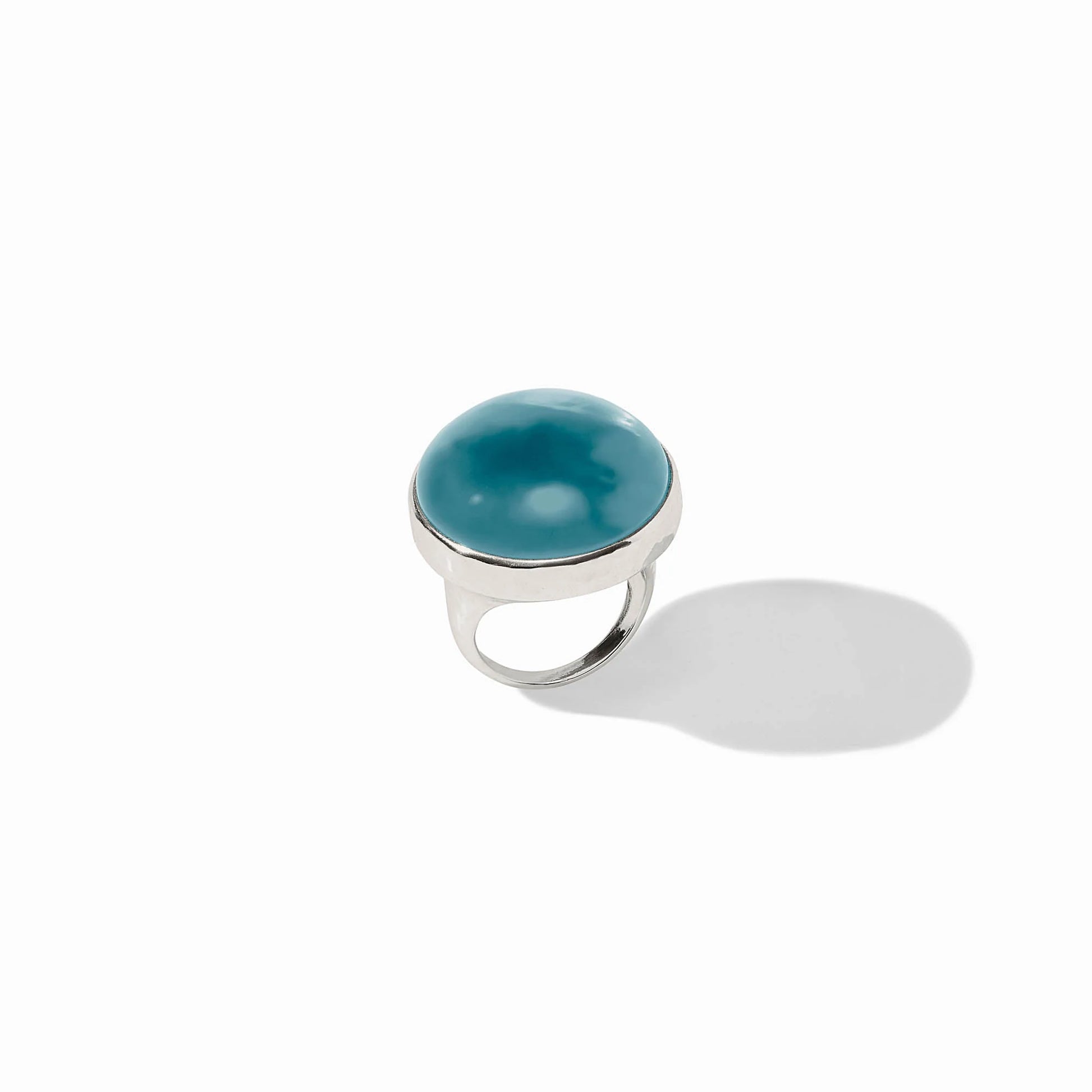 Solara Statement Ring in silver with a round iridescent blue stone bezel-set. Available sizes: 6, 7, 8.