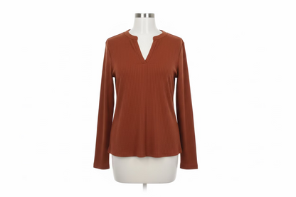 Burnt orange V-neck longsleeve with ribbed, textured fabric and split neckline. Available in sizes S-XL.