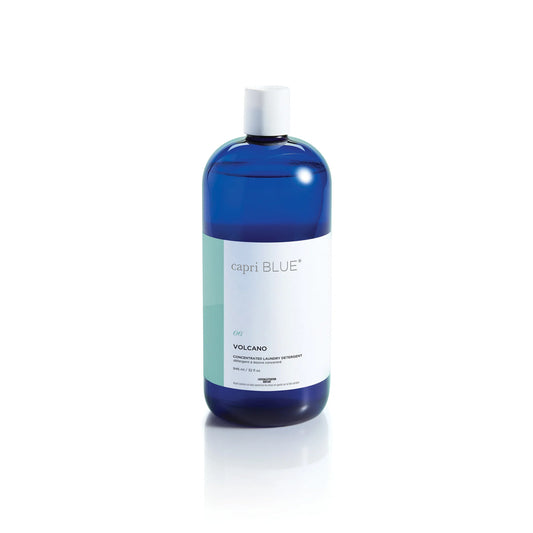 Blue bottle of Volcano Concentrated Laundry Detergent, Capri Blue scent, white cap, available in 32oz and 64oz sizes.