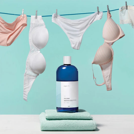 Blue bottle of Volcano Concentrated Laundry Detergent, available in multiple sizes, offers stain-fighting Capri Blue freshness.