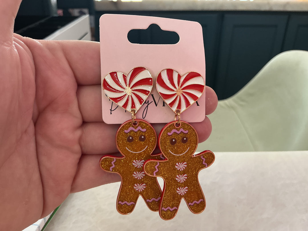 Glitter gingerbread girl cookie earrings with glittery brown dangles and white peppermint heart posts.