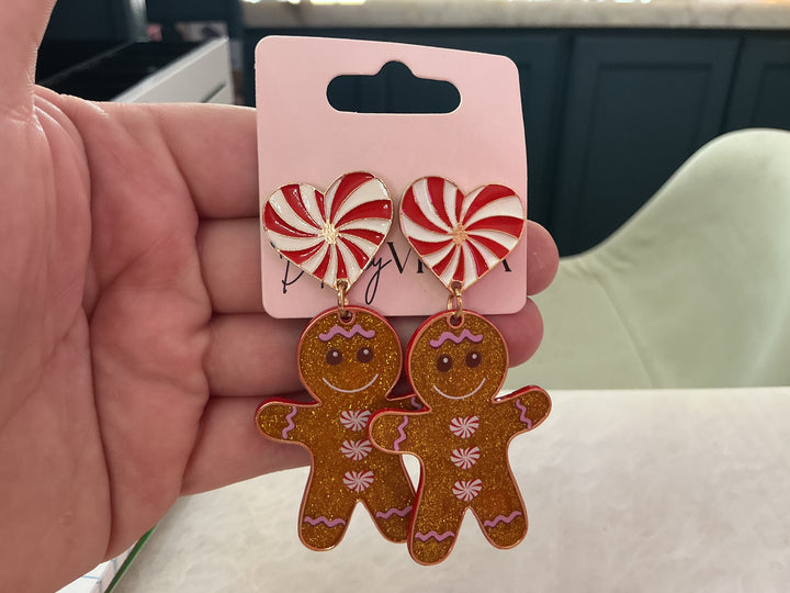 Glitter gingerbread girl cookie earrings with glittery brown dangles and white peppermint heart posts.