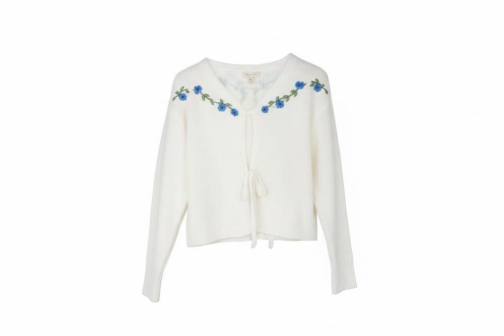 White flowered cardigan, long sleeves, front ties, blue embroidery on neckline/shoulders. Sizes: S, M, L, XL.