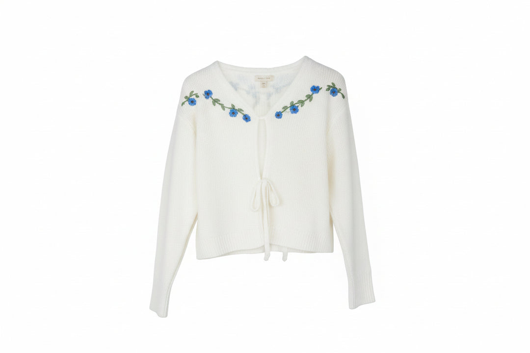 White flowered cardigan, long sleeves, front ties, blue embroidery on neckline/shoulders. Sizes: S, M, L, XL.
