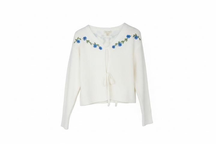 White flowered cardigan, long sleeves, front ties, blue embroidery on neckline/shoulders. Sizes: S, M, L, XL.