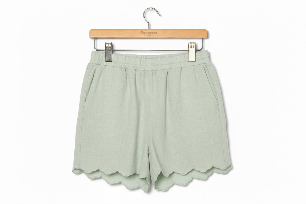 Light green Sage Scalloped Shorts with elastic waistband, side pockets, scalloped hems. Sizes: S-XL.