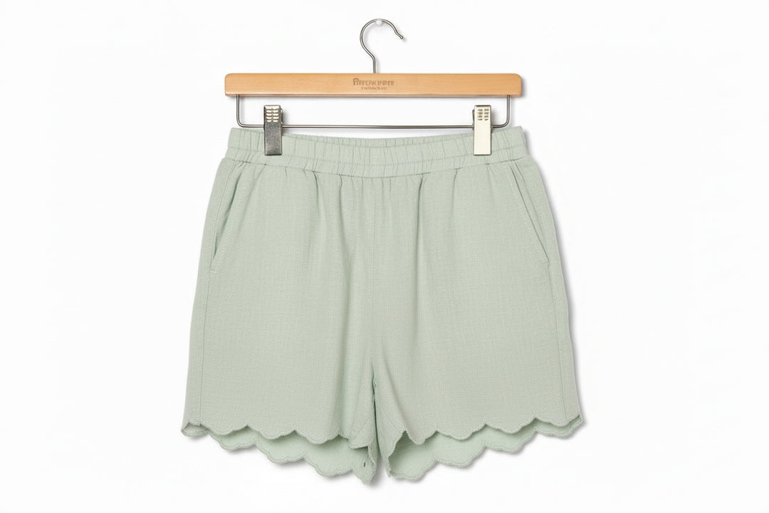 Light green Sage Scalloped Shorts with elastic waistband, side pockets, scalloped hems. Sizes: S-XL.