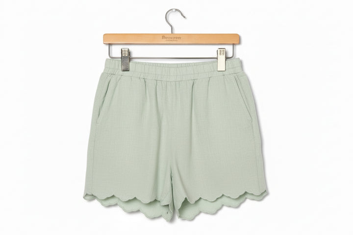 Light green Sage Scalloped Shorts with elastic waistband, side pockets, scalloped hems. Sizes: S-XL.
