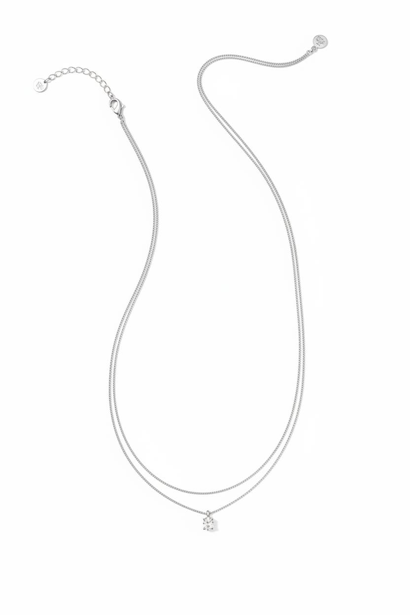 The Cailin Multi Strand Kendra Scott Necklace has delicate silver strands, a petite crown-shaped pendant, thin chain, adjustable clasp, and extension chain. Available in multiple sizes.