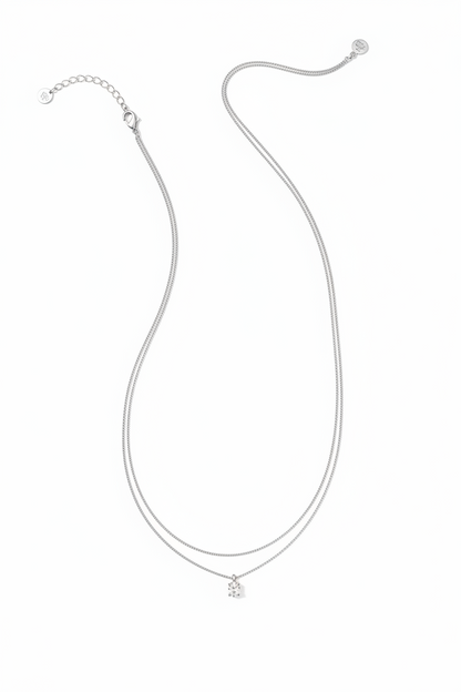The Cailin Multi Strand Kendra Scott Necklace has delicate silver strands, a petite crown-shaped pendant, thin chain, adjustable clasp, and extension chain. Available in multiple sizes.