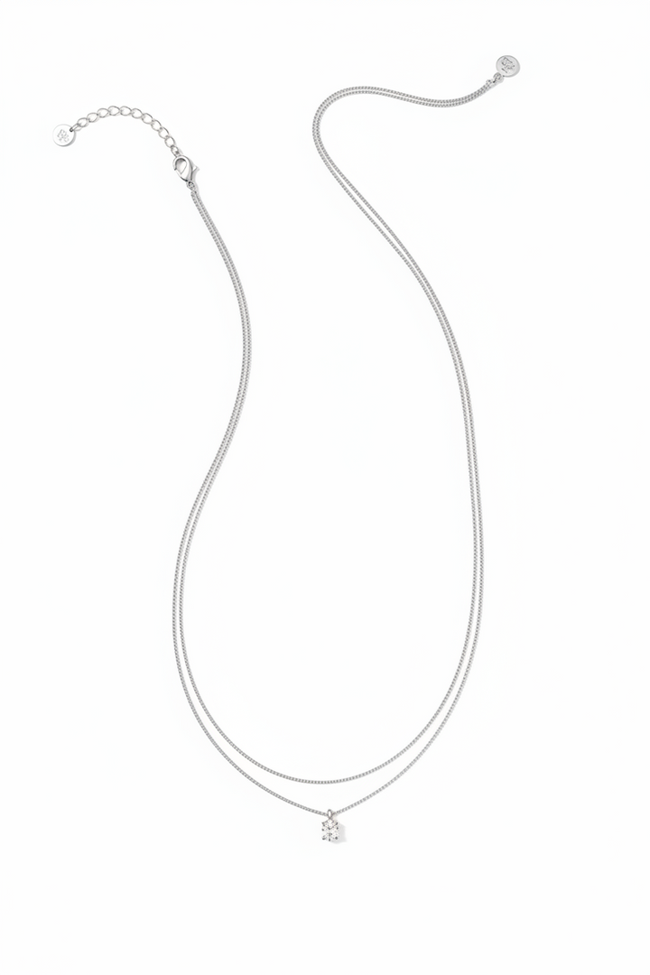 The Cailin Multi Strand Kendra Scott Necklace has delicate silver strands, a petite crown-shaped pendant, thin chain, adjustable clasp, and extension chain. Available in multiple sizes.