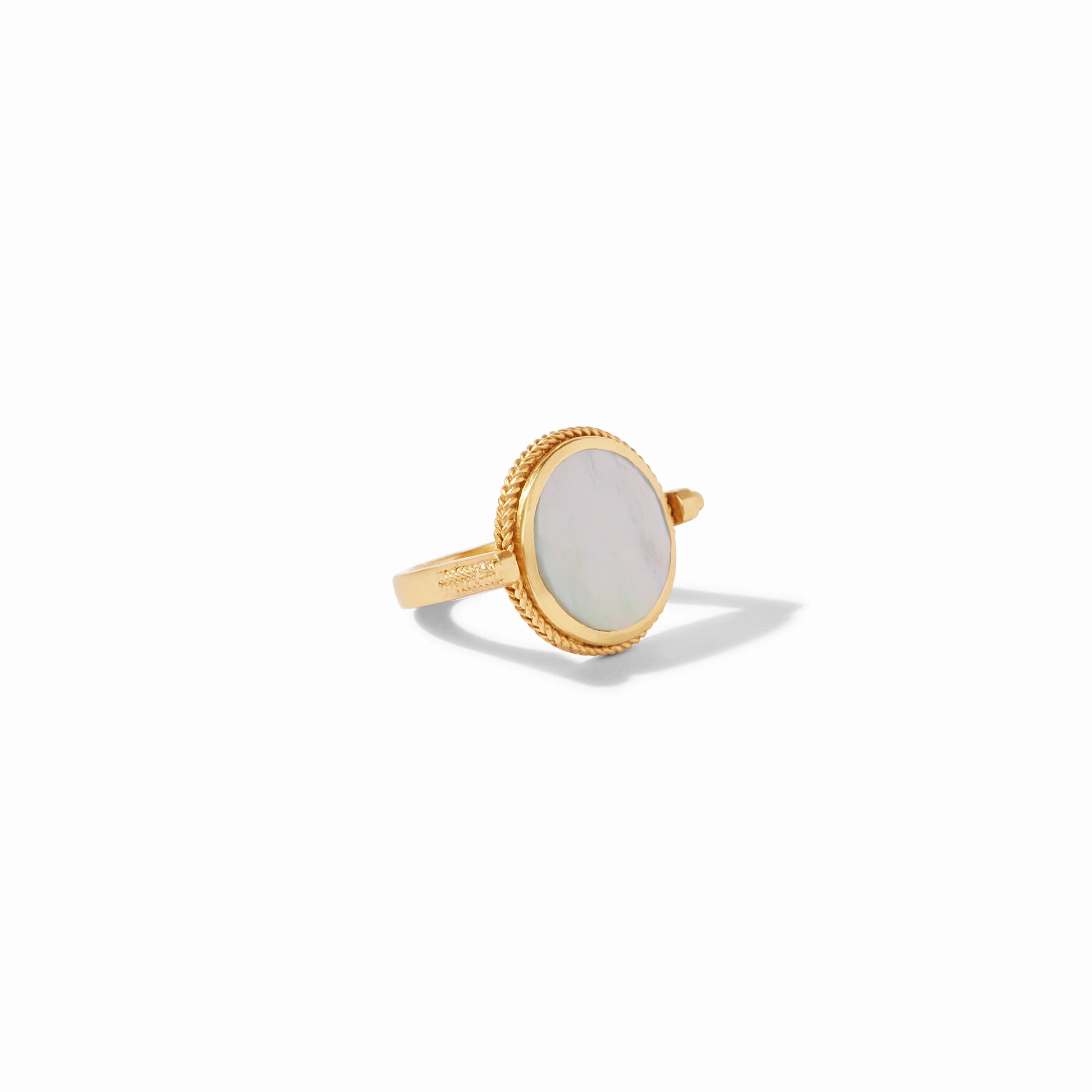 The Coin Revolving Ring by Julie Vos has a round mother-of-pearl center with a textured gold bezel. Available in multiple sizes.