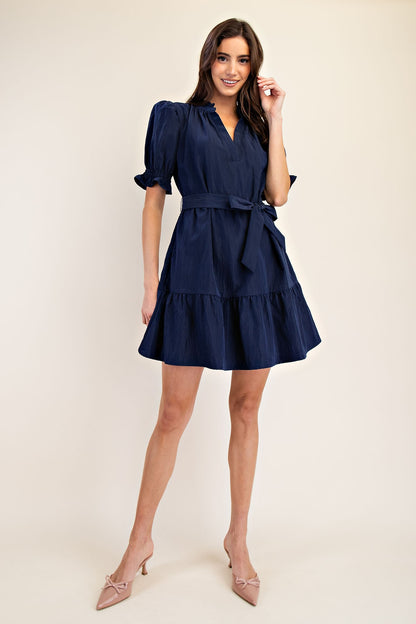 Mavis Navy Ruffle Neck Dress with short sleeves and flared skirt. Available in sizes XS-XL.