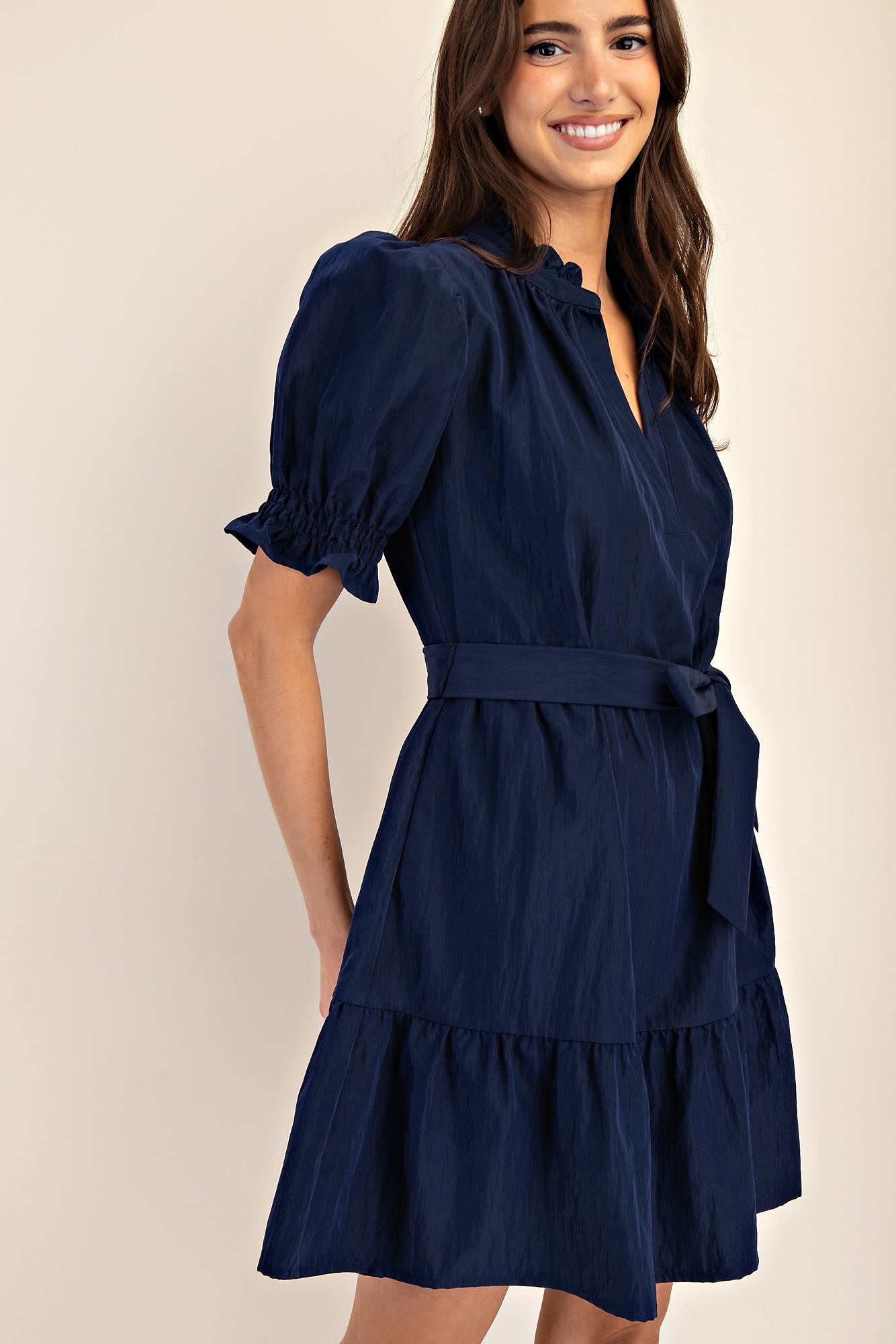 Mavis Navy Ruffle Neck Dress with tie waist, ruffled sleeves and hem. Available in sizes XS-XL.