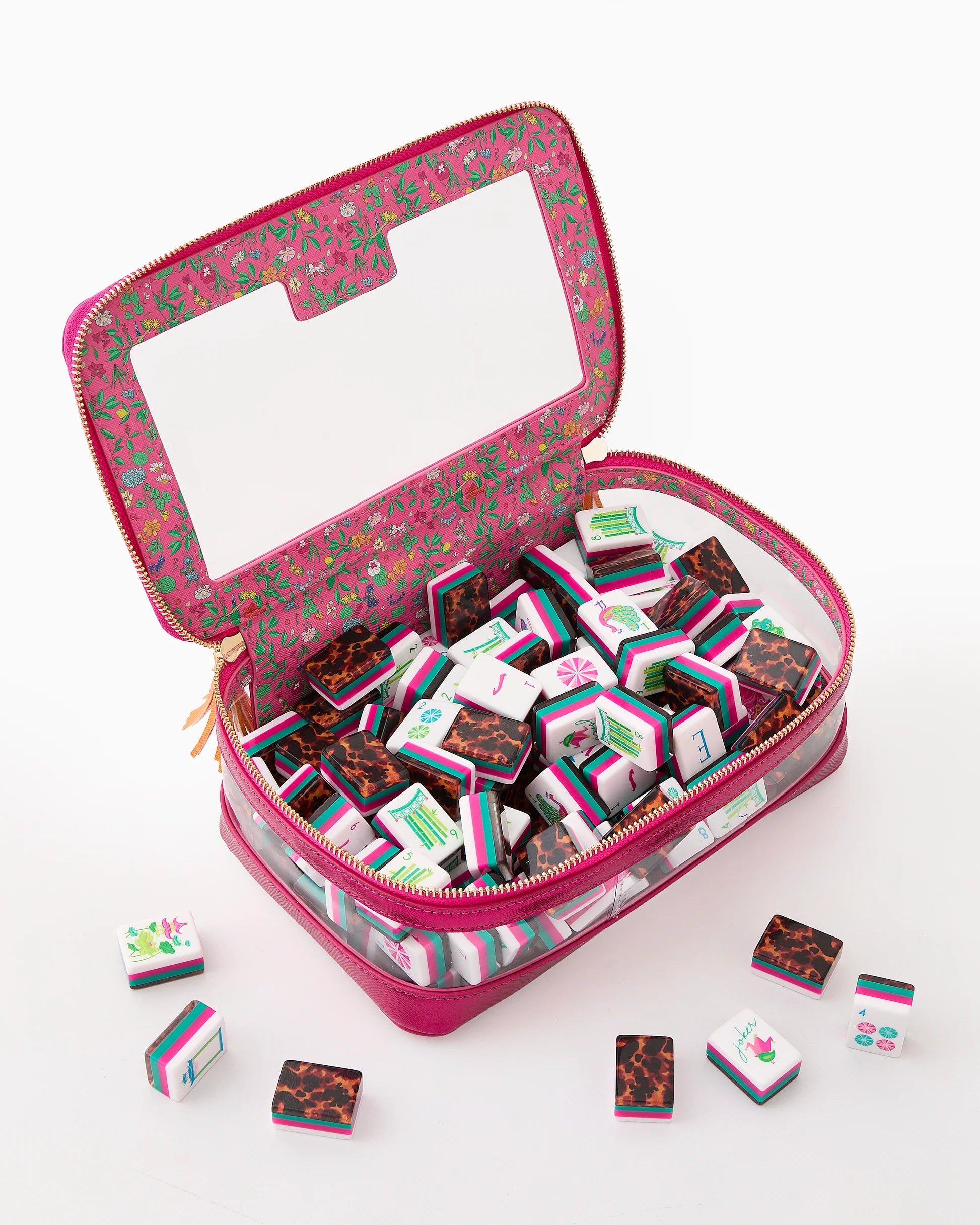 Clear pink zippered case with a large window and gold zipper pulls, featuring floral interior, holds colorful Glow Wild Mahjong Tiles. Available sizes: not specified.