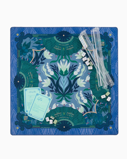 Mahjong Jade Mat in Tube with blue and green floral-patterned neoprene surface, bold shapes, and symmetrical patterns. Available in multiple sizes.