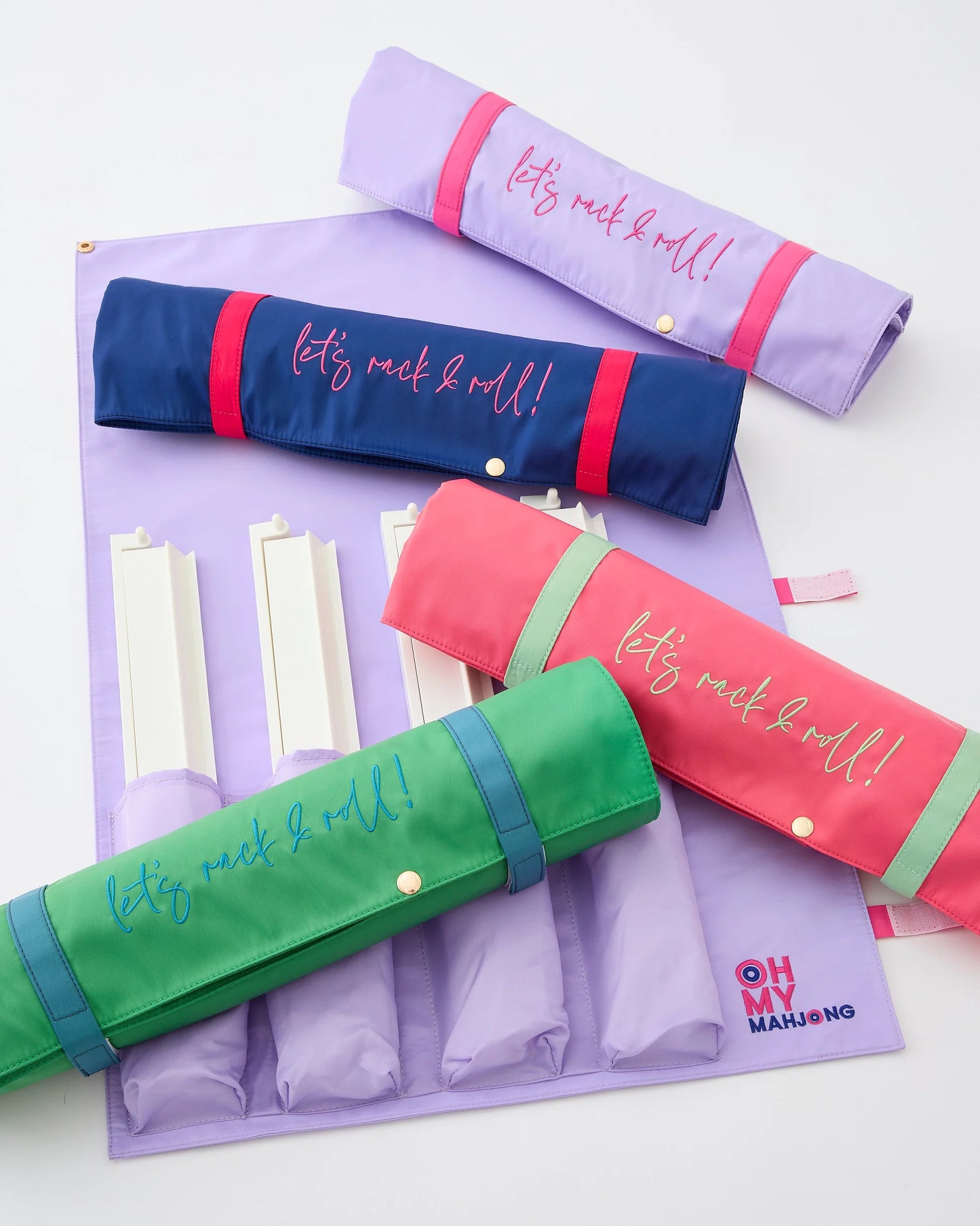 The Strawberry Pink Let’s Rack & Roll Bag is a vibrant roll-up organizer with “let’s rock & roll!” text. It features a pink “OH MY MAHJONG” logo in the corner. Available size: fits OMM 18.5" Rack & Pusher Sets.
