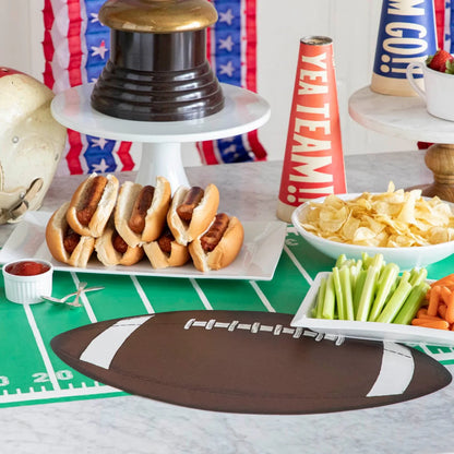 Football-shaped Die Cut Football Placemat Sheets displayed on a tabletop. Available in multiple sizes.