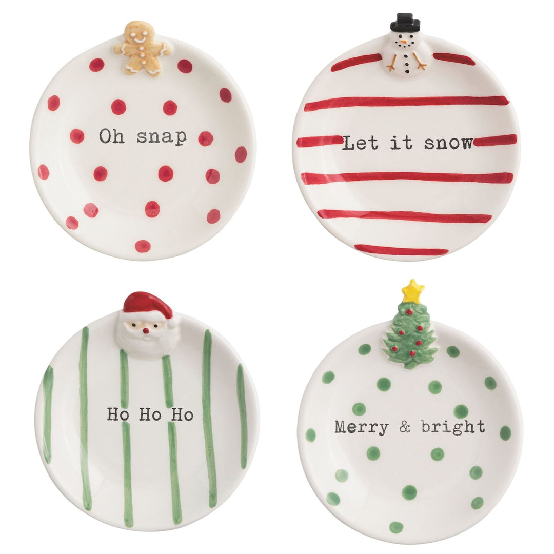 Four round ceramic Christmas trinket trays featuring gingerbread man, snowman, Santa Claus, and tree designs with festive text.