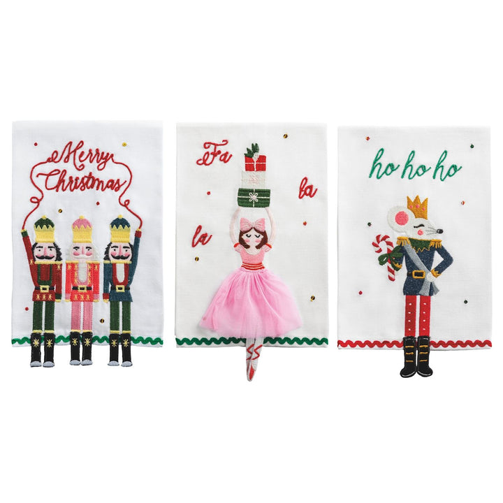 Three white hand towels with nutcracker, ballerina, and mouse embroidery.