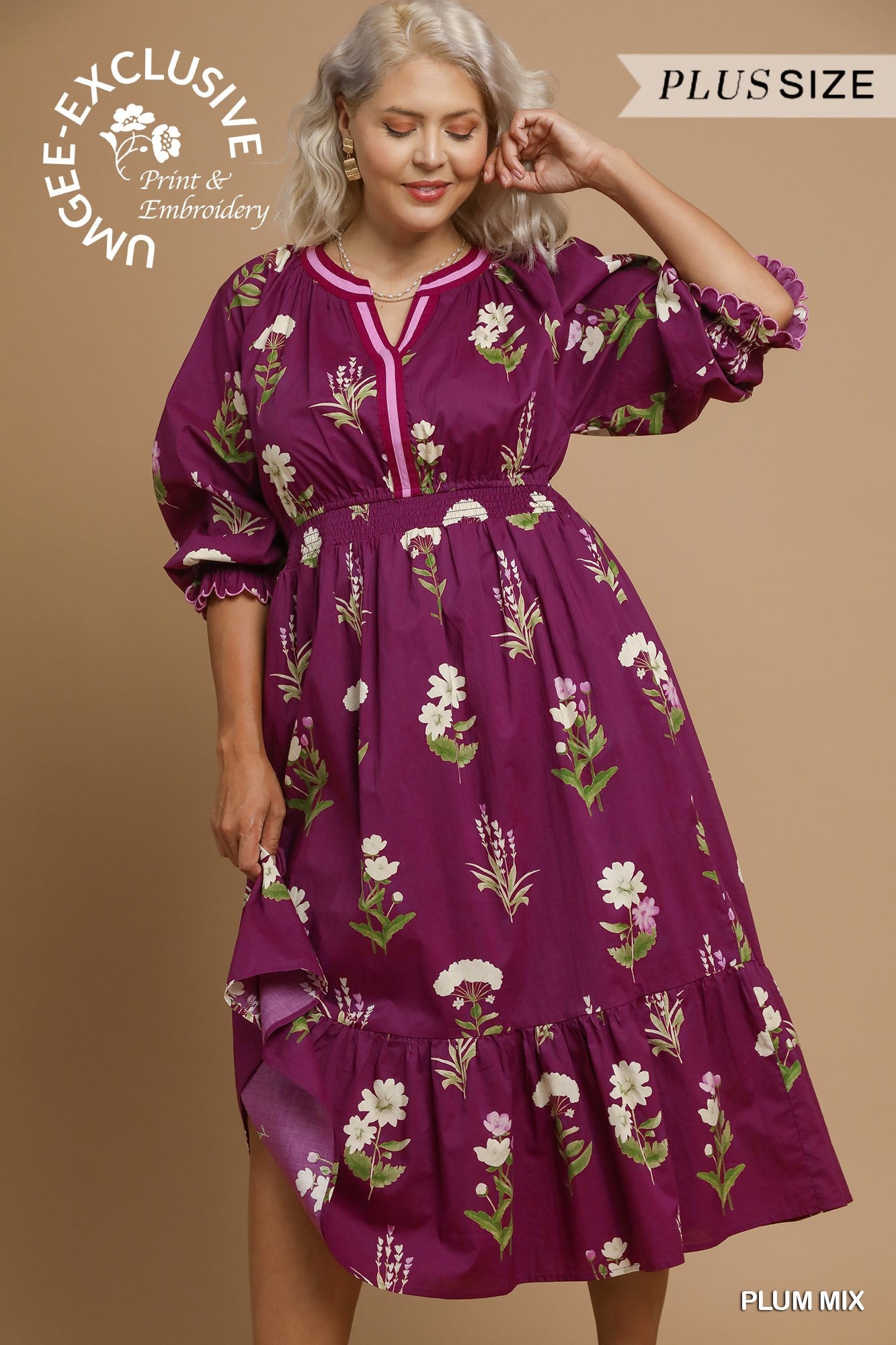Purple plus size dress with white and green floral patterns, ruffled sleeves and hem. Available in sizes 1X-4X.