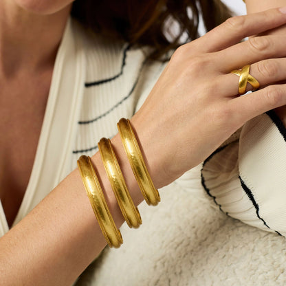 Three chunky Julie Vos Cannes Bangles in 24K gold plate, available in medium and large sizes.