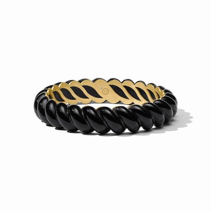 Glossy, chunky black resin bangle with twisted segments, 24K gold-plated interior, and bold chain link design. Available in S/M and M/L sizes.