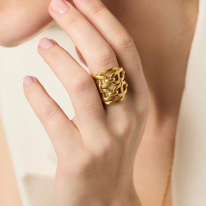 The Sahara Statement Ring is a large, chunky gold ring with an intricate, overlapping design. Available in sizes 6-9.
