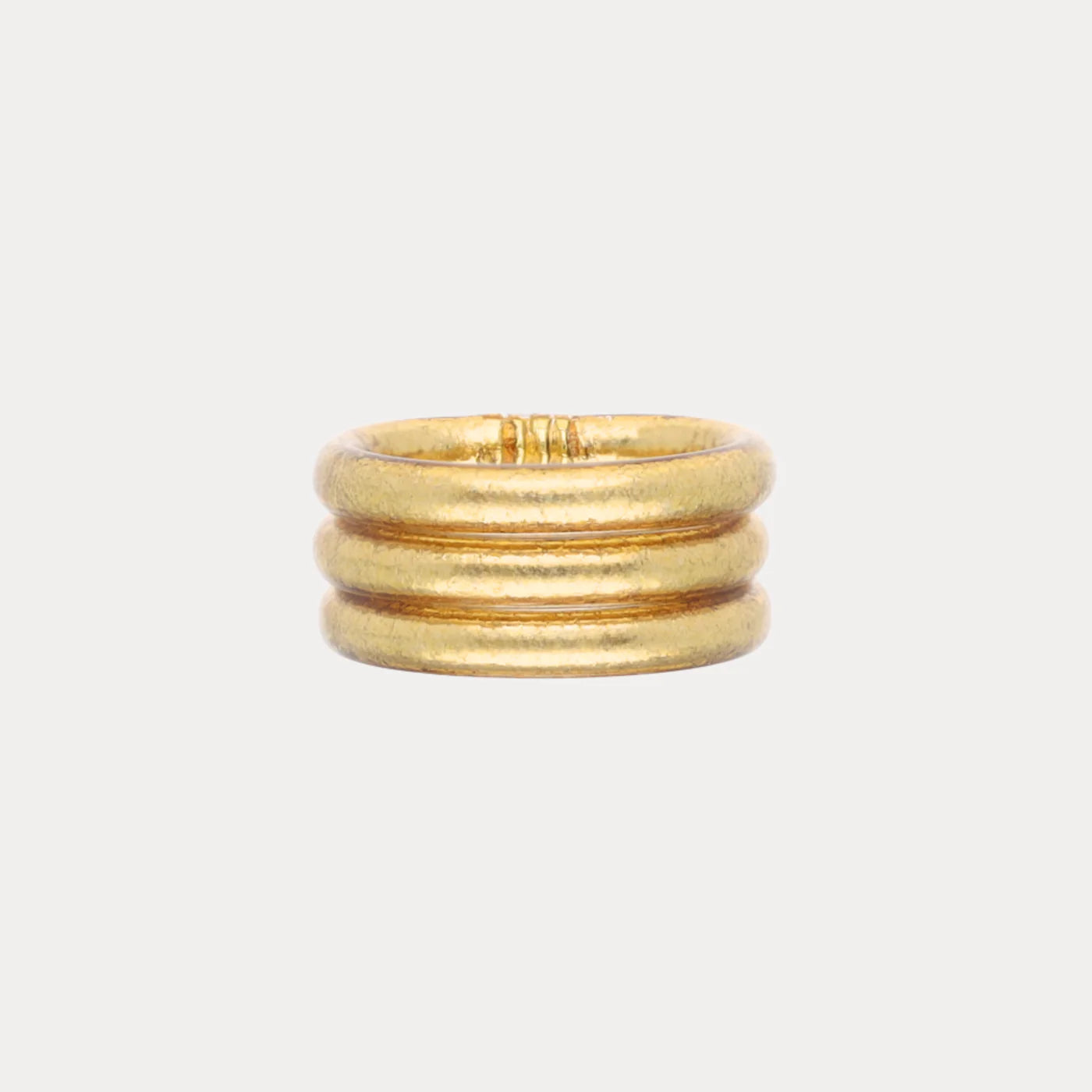 Set of three Aura All Weather Rings, size 7, gold matte finish with evenly spaced horizontal bands.