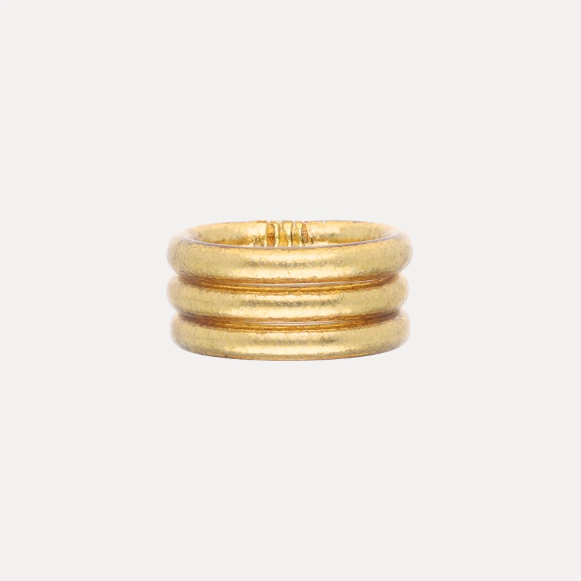 Set of three rounded gold bands, stacked together; waterproof and durable. Available in Size 7.