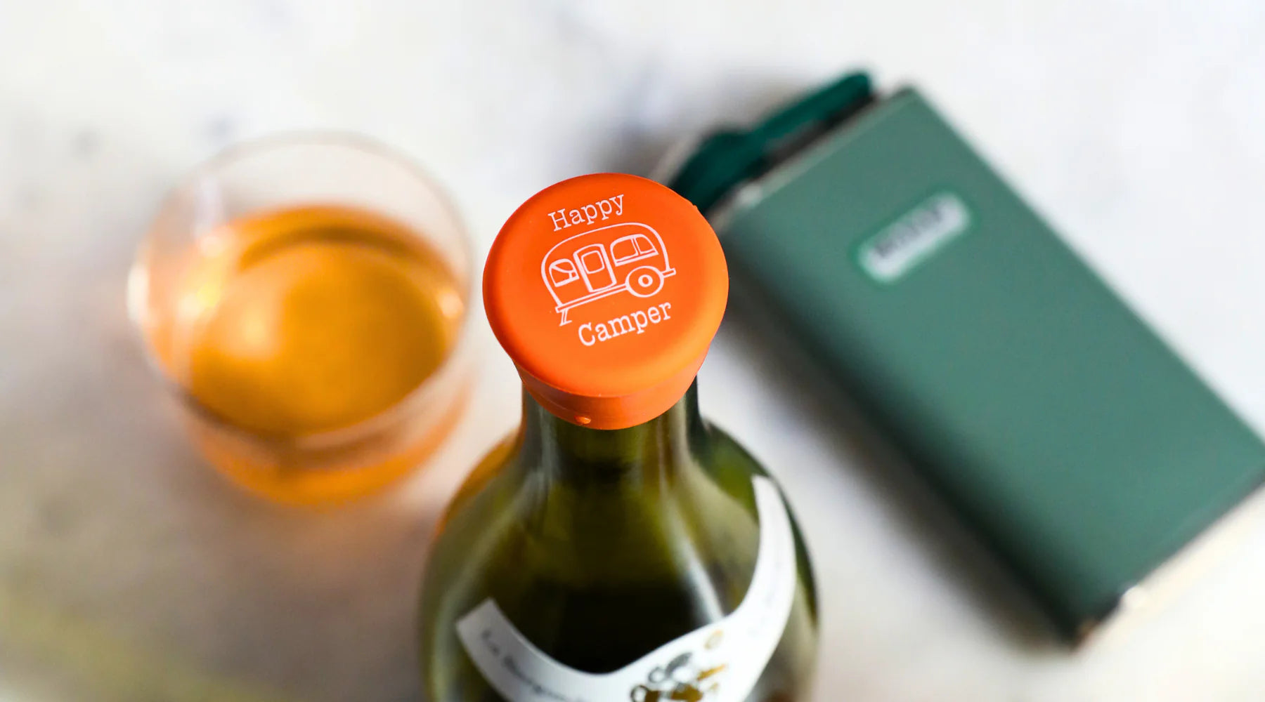 Orange Wine Caps bottle stopper with "Happy Camper" and camper trailer design. Available in multiple sizes.