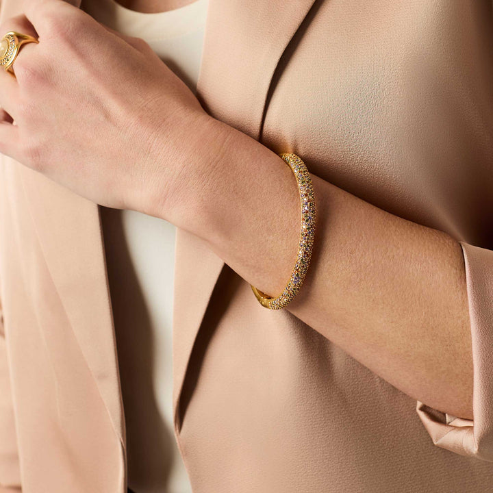 Stardust Hinge Bangle in 24K gold-plated metal with pavé-set multicolored CZ stones. Available in multiple sizes.