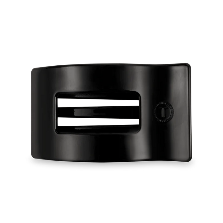 Jet Black TELETIES: black plastic buckle, three white stripes, bendable teeth; available in small, medium, and large sizes.
