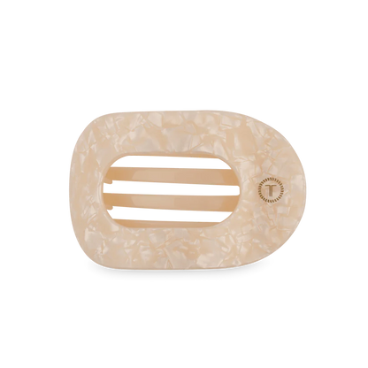 Cream-colored, marbled oval hair clip with three center slits and a "T" emblem; available in multiple sizes.