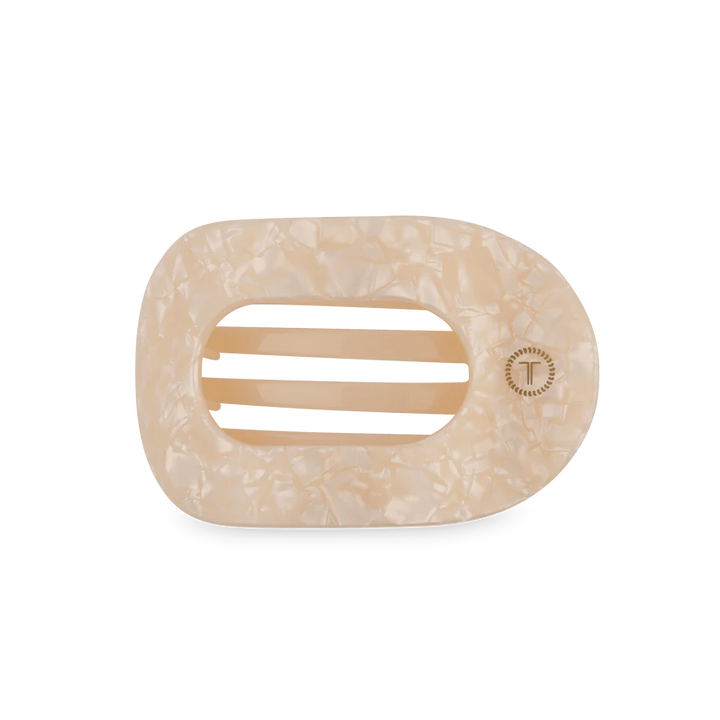 Cream-colored, marbled oval hair clip with three center slits and a "T" emblem; available in multiple sizes.