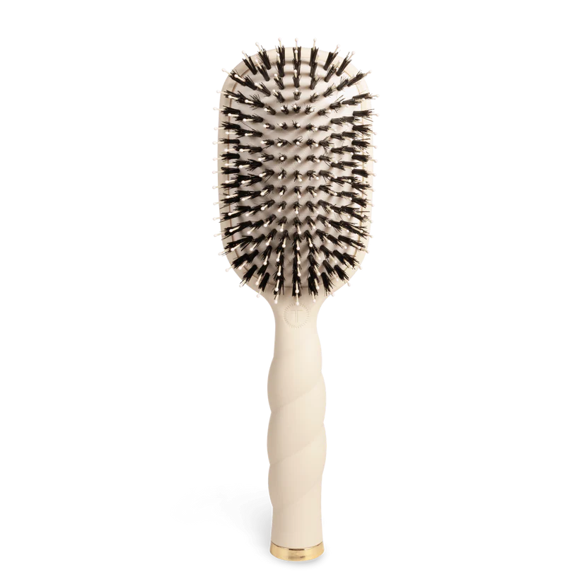 The Teleties Hair Brush is a beige detangler for thick hair with a twisted handle, gold accents, and anti-static dual-color bristles. Sizes: S/L.