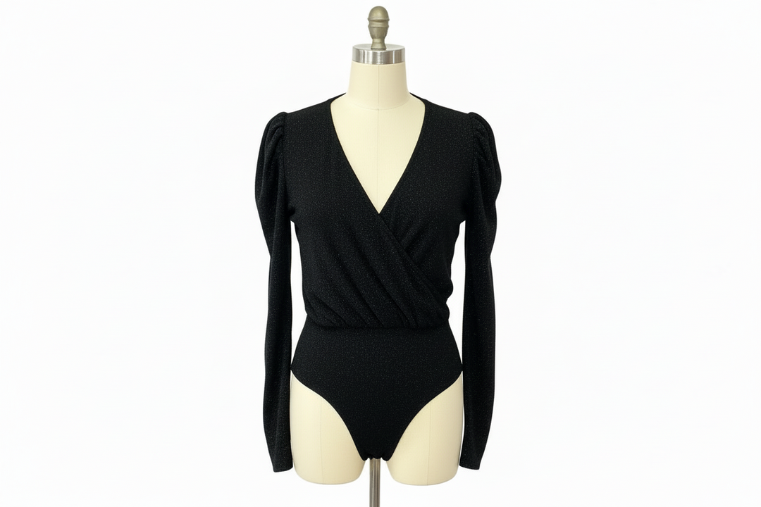 Black Long Sleeve Bodysuit by White Birch with deep V-neck and subtle puffed shoulders. Available in sizes S-XL.