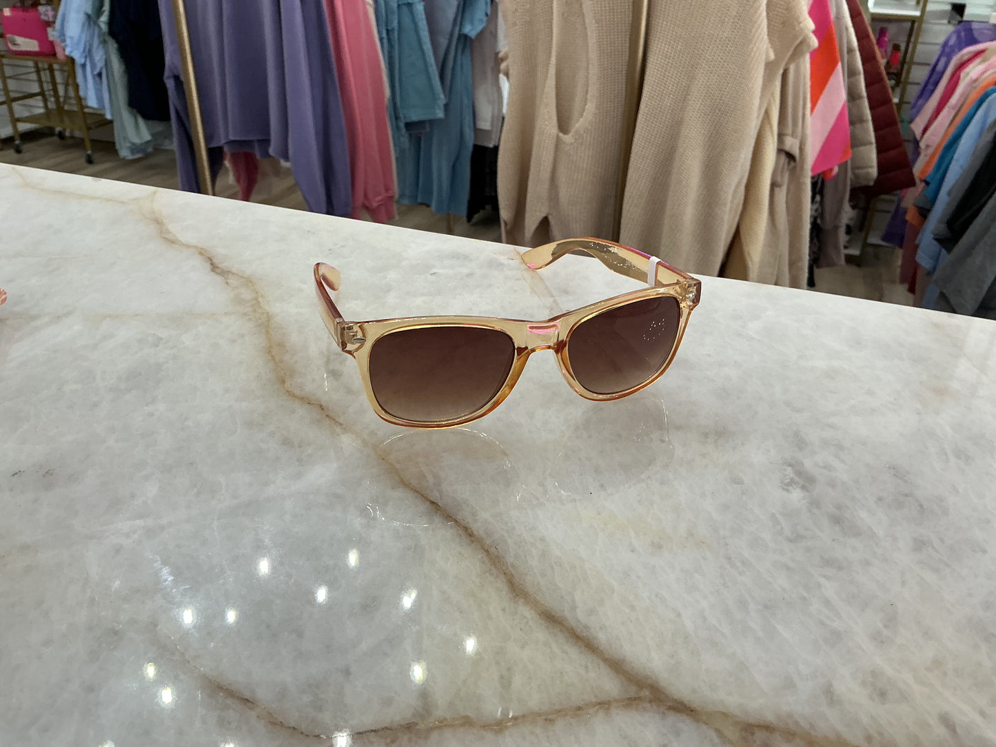 Amber sunglasses with beige and pink frames, UV protection. Available sizes: small, medium, large.