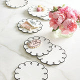Ceramic Scalloped Appetizer Plates feature a round white design with black scalloped edges and are available in multiple sizes.