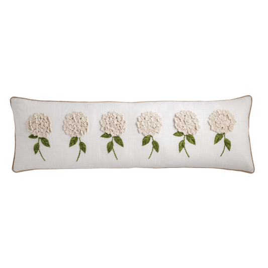 White pillow with six cream flowers, green stems and leaves embroidered on front. Sizes: 16"x16", 18"x18".