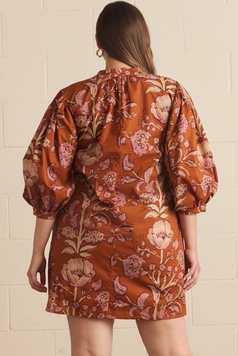 Autumn Rust Long-sleeve Dress with puffed sleeves, rust-colored background, and pink and cream floral pattern. Available in sizes XS–XL.
