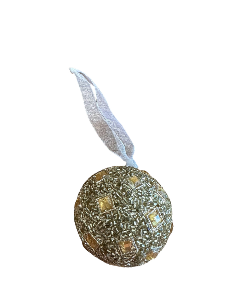 Round gold ornament with beads and square crystals, includes hanging ribbon.