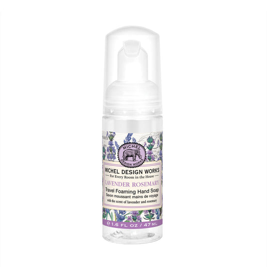 This is a Lavender Rosemary Travel foaming hand soap. The formula is enriched with shea butter for extra skin softness. It comes in a convenient white dispenser, decorated with delicate floral graphics to complement your space decor. The label presents an artistic interpretation of lavender and rosemary plants and includes descriptive text about the product's contents and uses.