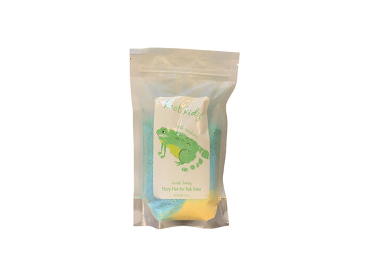Kool Kidz Bath Soakers cotton candy is a delightful teatime treat available in clear plastic bags. The packaging features an engaging green cartoon frog graphic. Inside, the tasty fluffy cotton candy is partially visible through the bag giving you a glimpse of what's to be enjoyed.