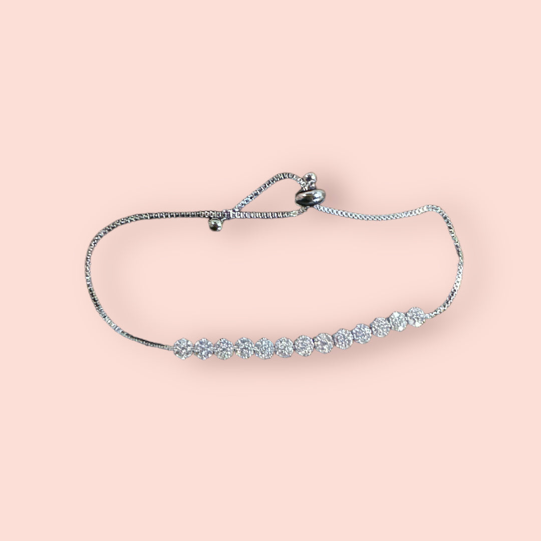 Diamond Circle Link Bracelet: delicate silver with round sparkling gemstones, adjustable sliding clasp; available in multiple sizes.