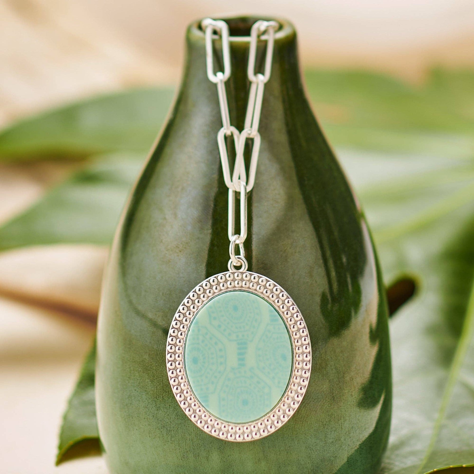 Seaside Green Reversible Link Medallion Necklace: Features a Maui Blue patterned center. Chain with elongated links. Sizes available: One size only.